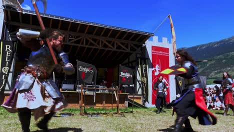 A-fighting-scene-with-weapons-performed-by-Burdyri,-a-professional-sword-and-stage-combat-team,-during-the-South-Tyrolean-Medieval-Games-2023,-hand-held