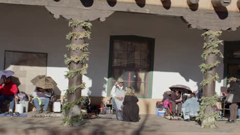 Tourists-shopping-from-street-vendors-in-downtown-Santa-Fe,-New-Mexico-plaza-with-video-panning-right-to-left