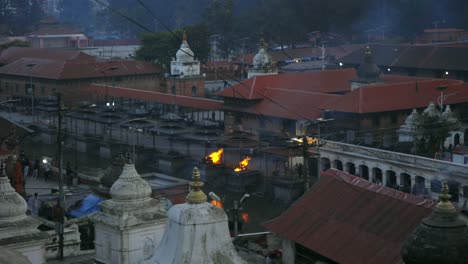 WIde-angle-overview-of-Buddhist-temple-in-Nepal-with-fire-and-smoke-coming-from-religious-pit