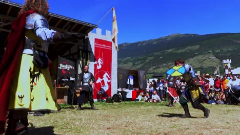 A-fighting-scene-with-weapons-performed-by-Burdyri,-a-professional-sword-and-stage-combat-team,-during-the-South-Tyrolean-Medieval-Games-2023,-hand-held