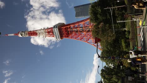 Looking-Up-At-Tokyo-Tower-On-Clear-Day-With-Azabudai-Hills-Building-In-Background