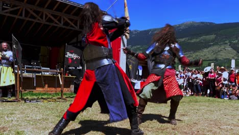 Fighting-scene-with-swords-performed-by-Burdyri,-a-professional-sword-and-stage-combat-team,-during-the-South-Tyrolean-Medieval-Games-2023,-hand-held