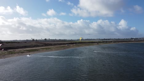 Aerial-View-Of-People-Kite-Surfing-On-Fiesta-Island-Park-In-San-Diego,-California