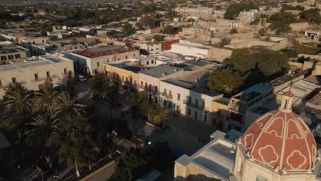 Aerial-View-a-the-dome-of-a-Mexican-church-in-a-charming-and-peaceful-town-at-dawn
