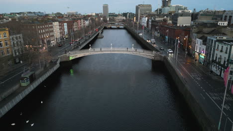 High-angle-aerial-overview-of-iconic-Ha'Penny-Bridge-in-downtown-Dublin-Ireland-above-river-Liffey