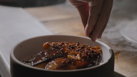 Garnishing-a-plate-of-sauteed-sweet-potatoes