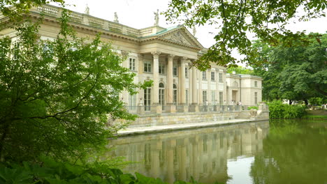Palace-on-the-Isle---Classic-architecture-of-a-palace-by-the-water-surrounded-by-trees