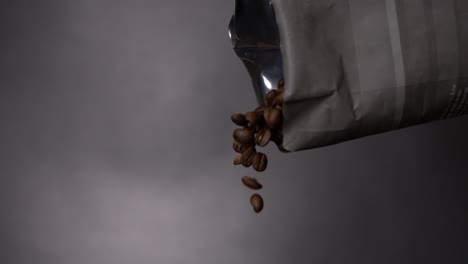 Coffee-bean-falling-out-of-a-bag-in-a-coffee-machine-in-super-slow-motion