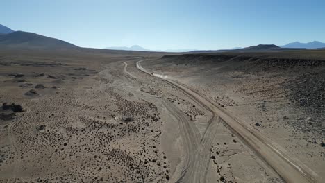 Vehicle-traveling-on-dirt-road-near-Eduardo-Avaroa-National-Reserve,-Bolivia