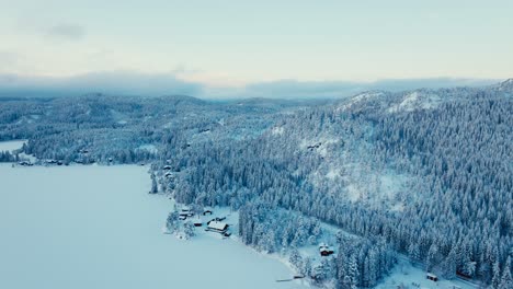 Village-By-The-Mountainside-Forest-Covered-In-Snow-During-Winter