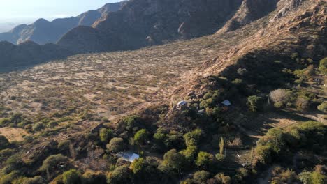 Aerial-circling-cabin-on-top-of-mountain-on-outskirts-of-Salta,-Argentina