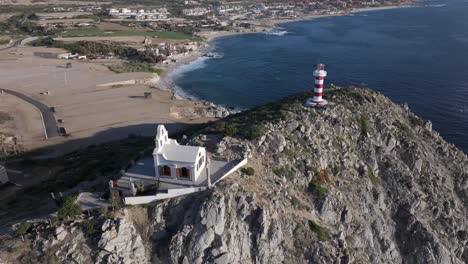 Spanish-style-church-on-a-mountain-next-to-El-Encanto-Lighthouse-in-Mexico---aerial-orbit