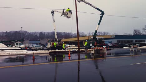 Linemen-work-on-downed-electrical-cables-cause-by-heavy-wind-and-rain-storn