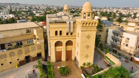 Ornate-Al-Burhani-Mosque-facade,-Karachi---aerial-panoramic
