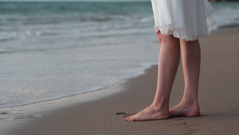 Young-woman-in-white-dress-enjoying-the-tropical-beach