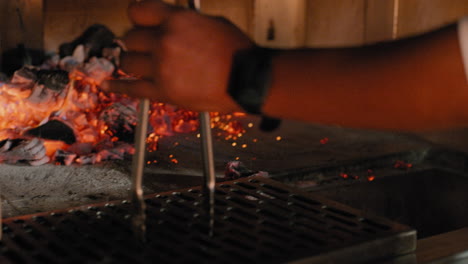 Raking-coals-into-a-wood-fired-grill