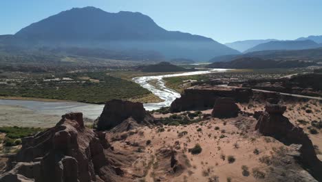 Aerial-heading-towards-winding-river-on-sunny-day,-Northern-Argentina