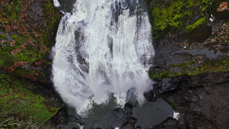 4K-drone-footage-flying-above-waterfall-in-forest