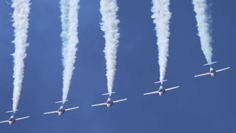 Close-Up-Shot-of-Formation-of-Jet-Planes-Pulling-Up-from-a-Looping