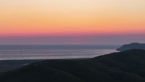 Colorful-sky-sunset-timelapse-over-Adriatic-sea-and-dark-shore-hillside