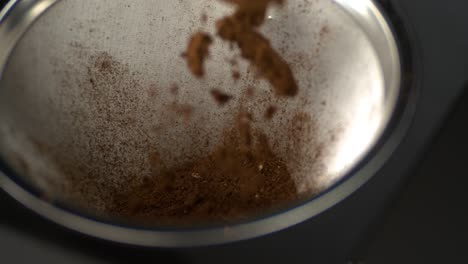 Ground-coffee-falling-into-a-coffee-machine-filter-in-super-slow-motion