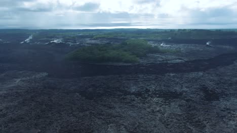 Aerial-fresh-black-volcanic-rock-deserted-landscape-in-Leilani-Estates,-Big-Island,-Hawaii-USA