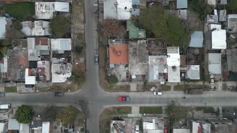 Aerial-birdseye-descending-over-houses-in-residential-neighborhood,-Argentina
