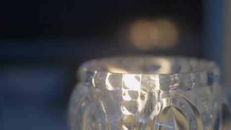 Closeup-of-a-scented-candle-burning-inside-a-glass-flask