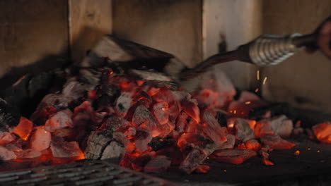 Raking-coals-into-a-wood-fired-grill