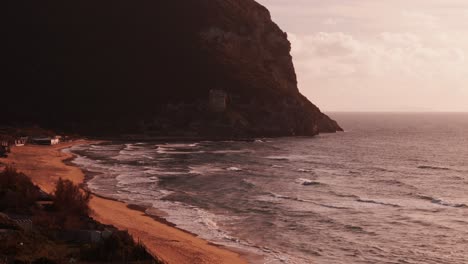 Italian-coastline-close-to-Rome-Sabaudia,-Circeo-Parallax-long-shot-with-a-castle-as-protagonist,-Sunset