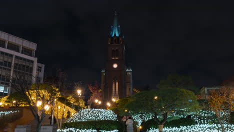 Crowded-with-Tourists-Myeongdong-Cathedral-Park-at-Night-on-Christmas-Eve,-Time-Lapse-in-Seoul,-South-Korea