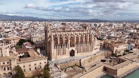Aerial-establishing-shot-of-famous-cathedral-of-Mallorca-on-Palma-City-at-sunlight