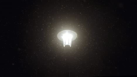 A-lantern-lighting-up-the-snow-around-it-during-a-cold-blizzard-at-night