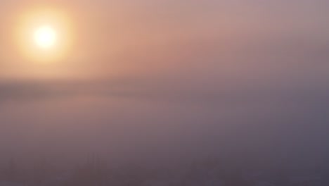 Golden-sunrise-drone-view-as-it-rises-out-the-morning-fog