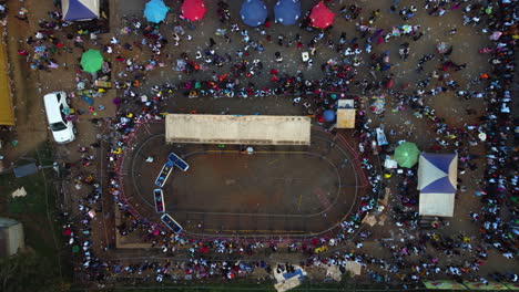 Top-down-drone-shot-above-people-and-rides-at-the-Yafe-Yaounde-Festival,-in-Africa