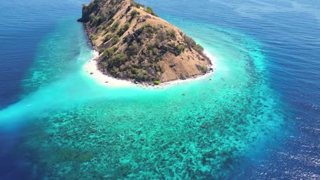 Drone-video-over-a-small-island-surrounded-by-coral-reefs