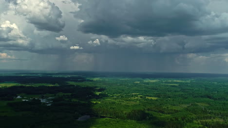 Aerial-view-of-a-lush-landscape-under-the-dramatic-sky-of-an-approaching-storm