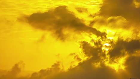 Golden-sunlight-streaming-through-dynamic-clouds,-creating-a-vibrant-and-dramatic-skyscape