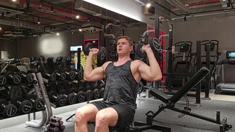 Man-in-30s-Doing-Seated-Dumbbell-Shoulder-Press-in-Gym