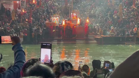 pov-shot-Many-people-are-enjoying-Ganga-Aarti-and-many-people-are-taking-videos