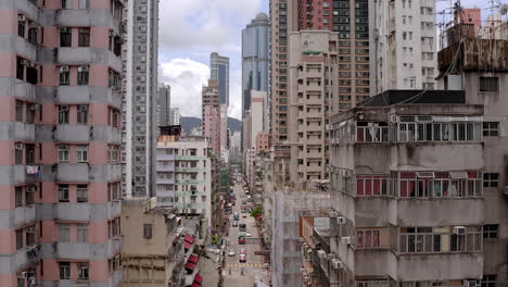 Hong-Kong-daytime-panoramic-view-aerial-footage-between-residential-homes,-cyberpunk-cityscape,-construction-old-residential-building,-developing-metropolis,-booming-economy,-housing-crisis,-landmarks