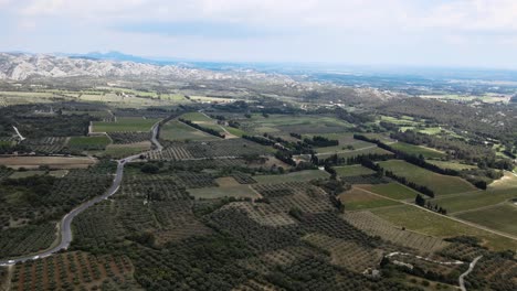 Beautiful-aerial-establishing-shot-of-expansive-fields-at-Les-Beaux-de-Provence-in-France