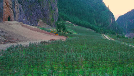 Greenery-landscape-drone-shot-around-Manag-Annapurna-region,-JCB-excavator-construction,-apple-trees-devastation-farm-Nepal-4K