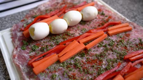 Julienne-Cut-Red-Peppers-And-Carrots,-Hard-Boiled-Eggs,-And-Herbs-On-Sliced-Beef-Meat-Before-Rolling
