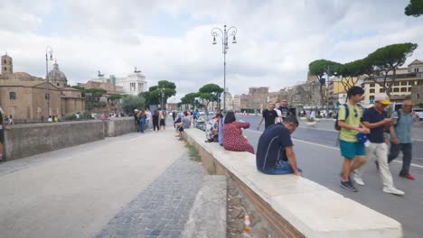 Rome-Immersive-POV:-Moving-In-Busy-Streets-to-Chiesa-Santi-Luca-e-Martina,-Italy,-Europe,-Walking,-Shaky,-4K-|-Tourists-Resting-While-Others-Pass-Near-Ruins