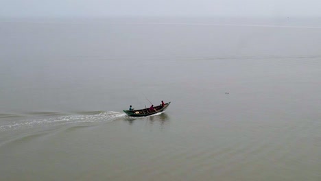 Small-fishing-boat-speeding-into-Indian-ocean-to-catch-food,-aerial-view