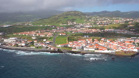 Horta-suburbs-amidst-green-volcanos-and-Atlantic-Ocean,-Faial,-Azores