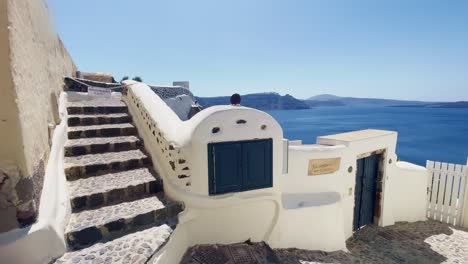 People-On-Steps-Sitting-|-Oia-Santorini-Greece-Greek-Island-in-Aegean-Sea,-Travel-Tourist-Vacation-Immersive-Moving-Walk-Along-Crowds-Shopping-in-White-Marble-Cliffside-and-City,-Europe,-4K
