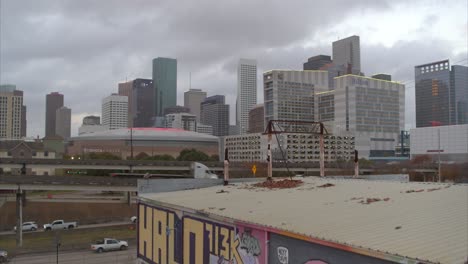 Wide-angle-aerial-shot-that-reveals-downtown-Houston,-Texas-from-graffiti-wall-district