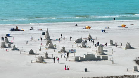 Sand-Sculptures-and-people-walking-around-at-Sanding-Ovation-Master-Cup-2023-at-Madiera-Beach,-FL